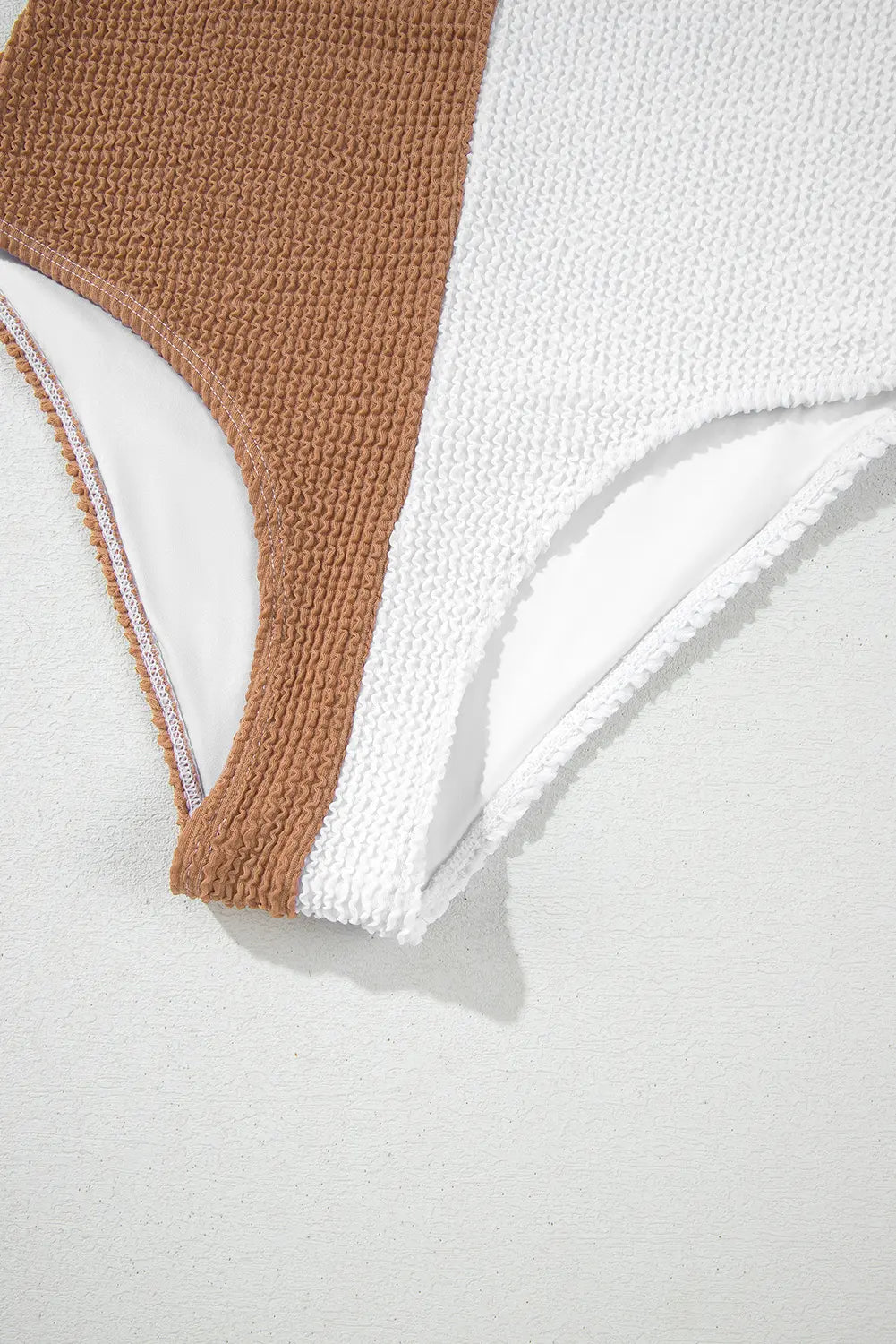 Close-up of a brown and white fabric swatch on a light gray background