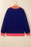 Navy blue sweater with red-white polka-dot trim at collar, cuffs, and hem.