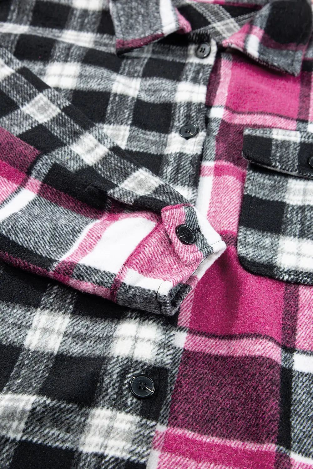 Close-up of a plaid shirt with pink, black, and white pattern