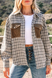 Person wearing a plaid shirt with brown pocket flaps and blue jeans outdoors.