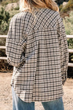 Person wearing a plaid jacket with a natural outdoor background