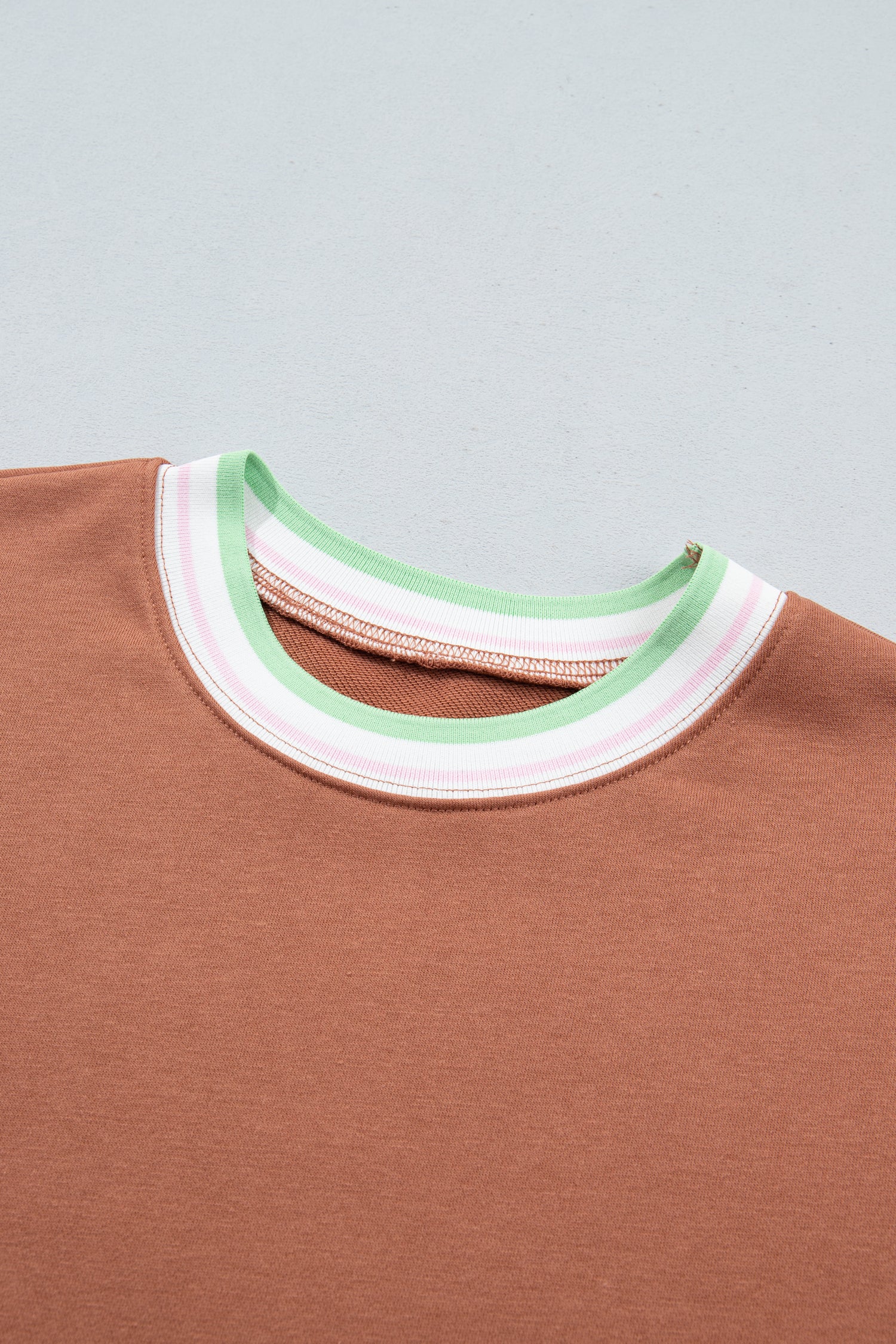 Close-up of a crewneck sweatshirt showing the ribbed collar 