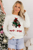 Woman in cream Christmas sweater with green tree, red bows, and 'Merry and Bright' text with denim shorts.
