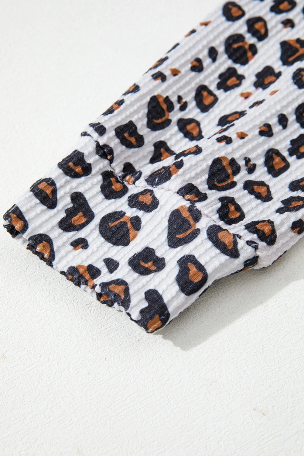 Leopard print fabric on a white background.