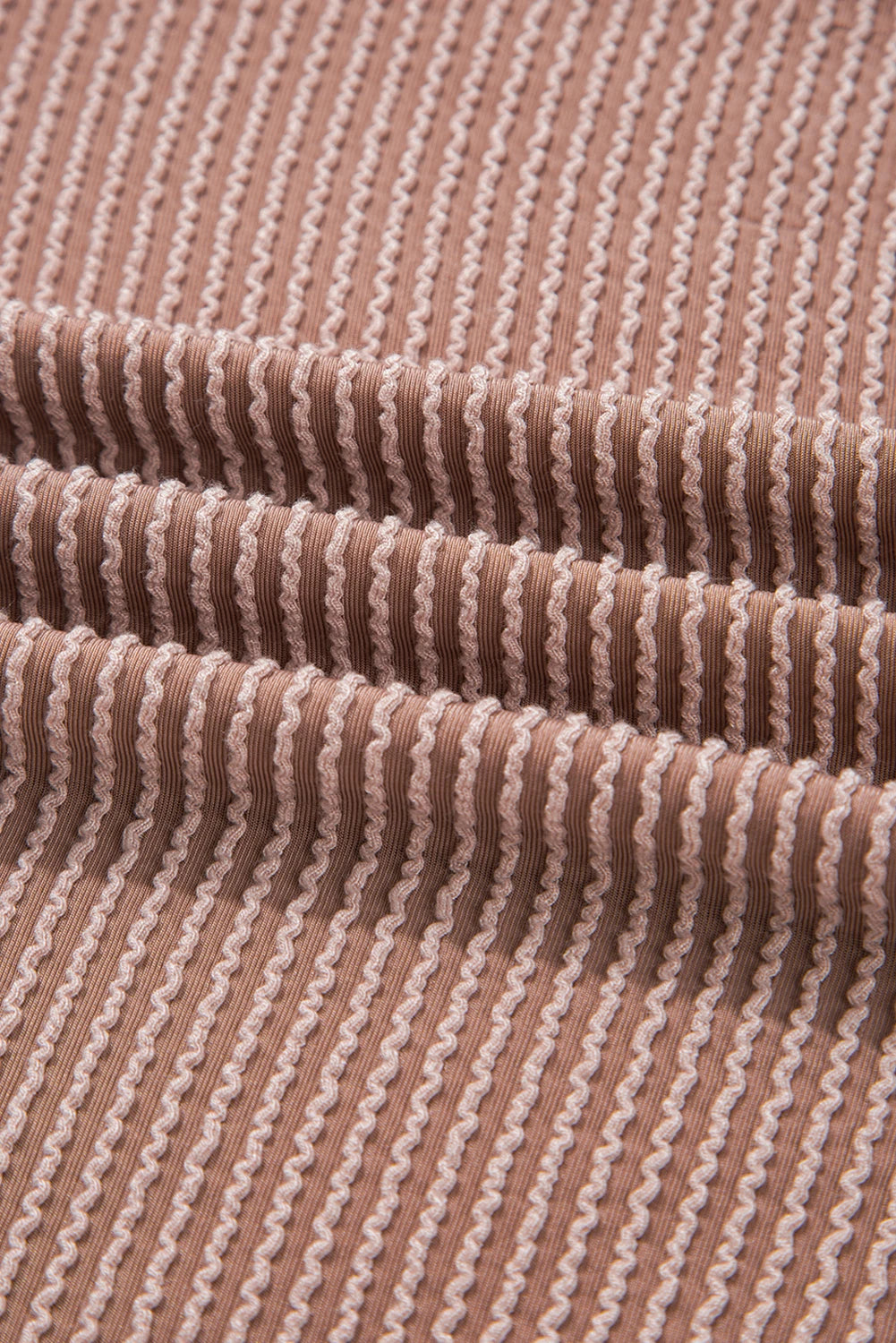 Close-up of ribbed fabric with a brown and beige pattern.