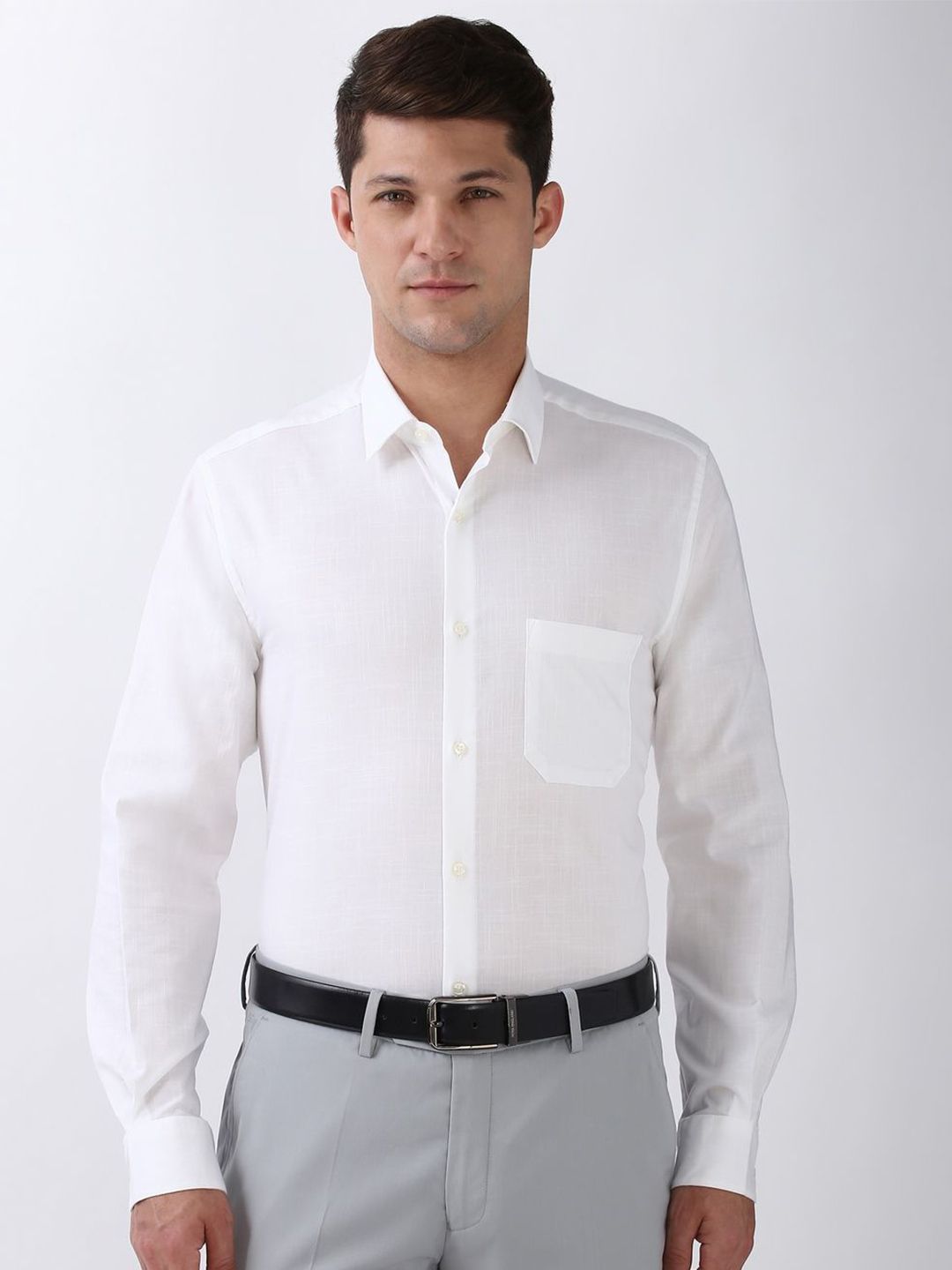 Man wearing a white dress shirt and gray pants on a white background