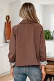 Person wearing a brown jacket in a kitchen setting