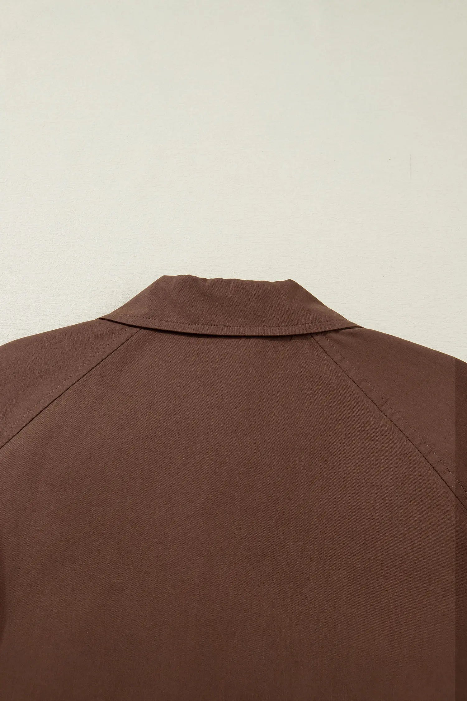 Brown jacket on a beige background