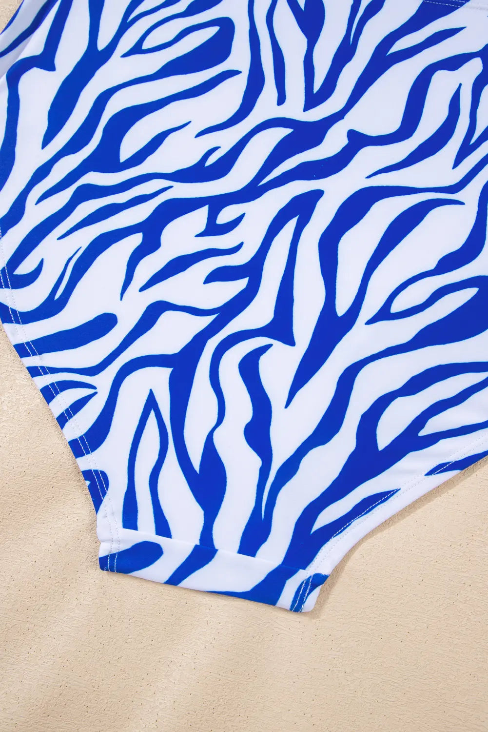 Blue and white zebra patterned fabric on a beige background