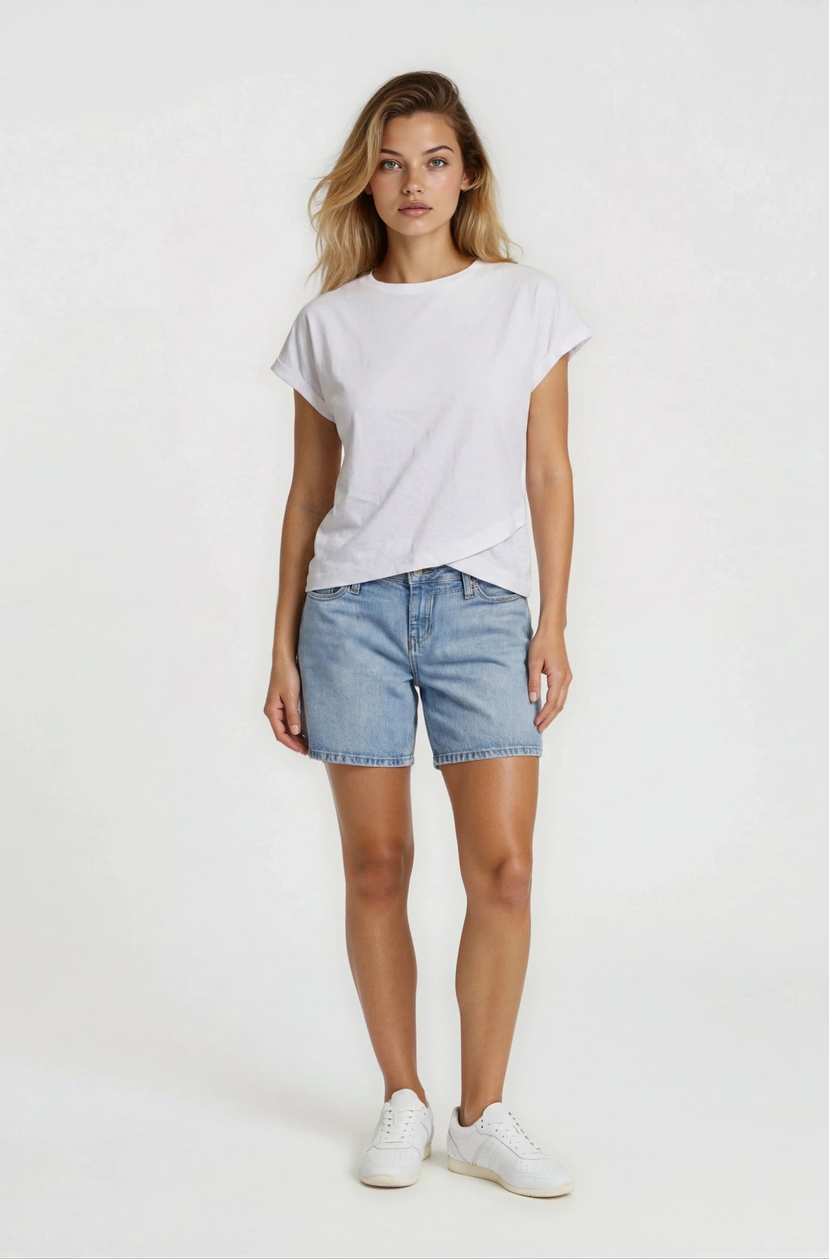 Woman wearing a white t-shirt and denim shorts on a white background