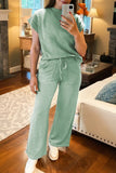 Person wearing a green outfit in a living room setting