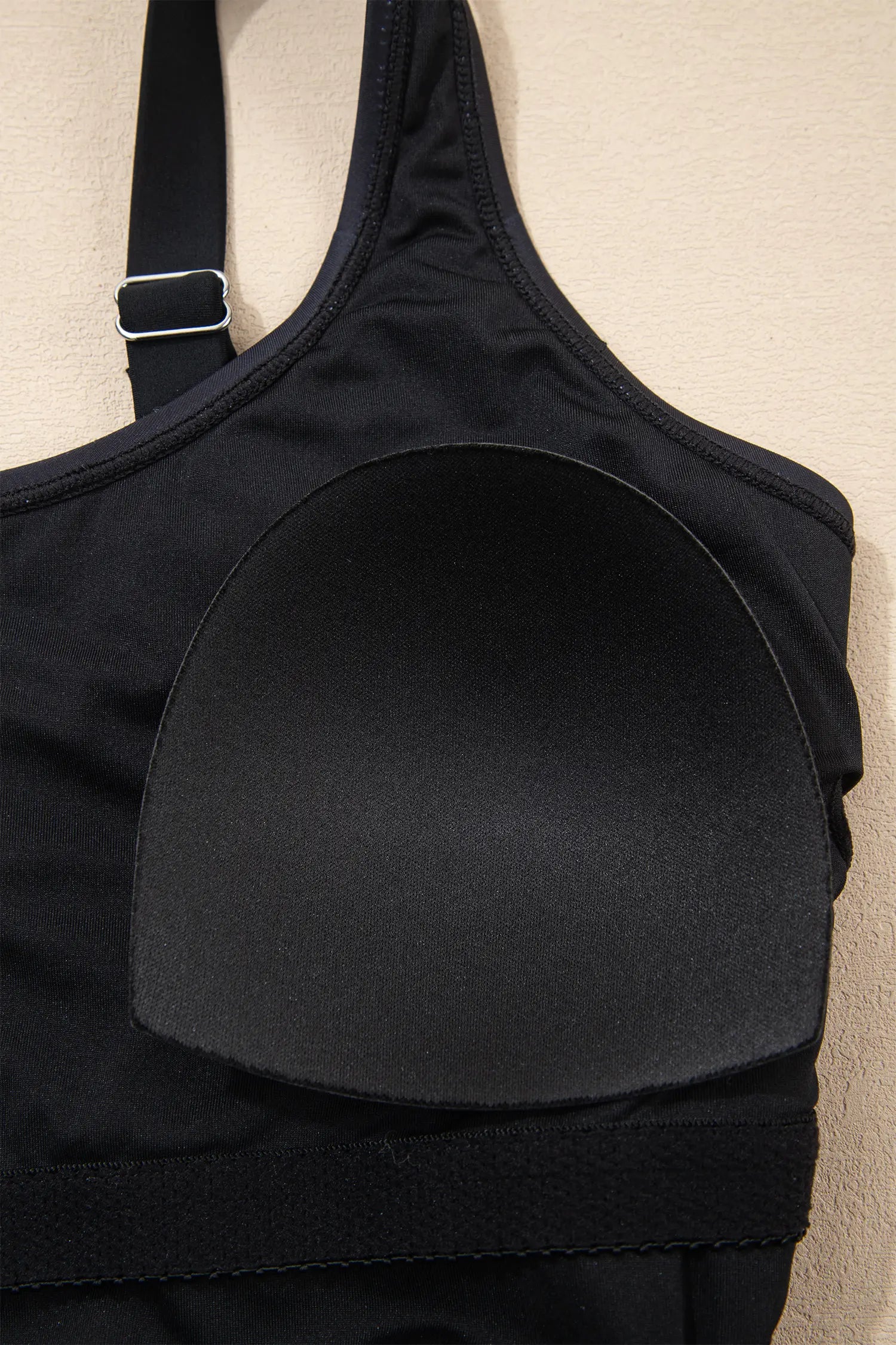 Black bra on a beige background