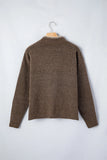 A brown knit sweater with a textured, heathered finish, hanging on a wooden hanger against a light gray background.