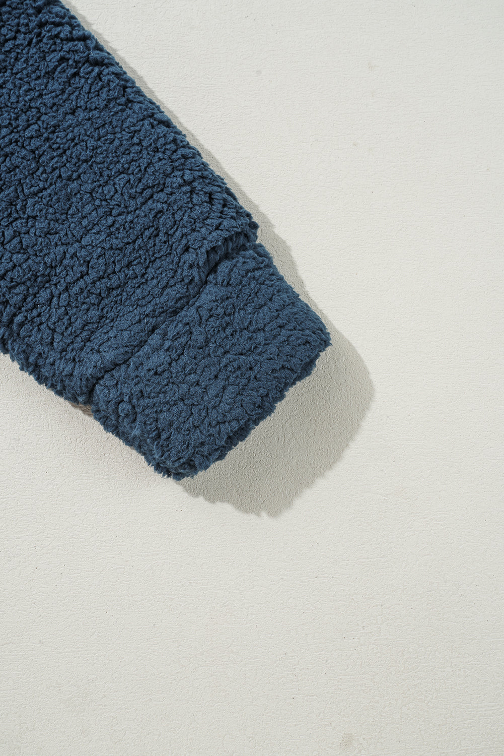 Blue textured fabric on a light gray background