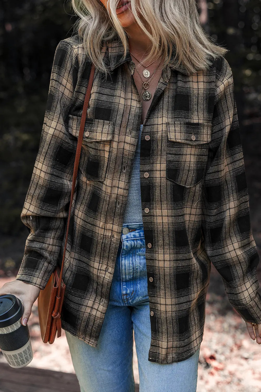 Person wearing a plaid shirt with a blurred background