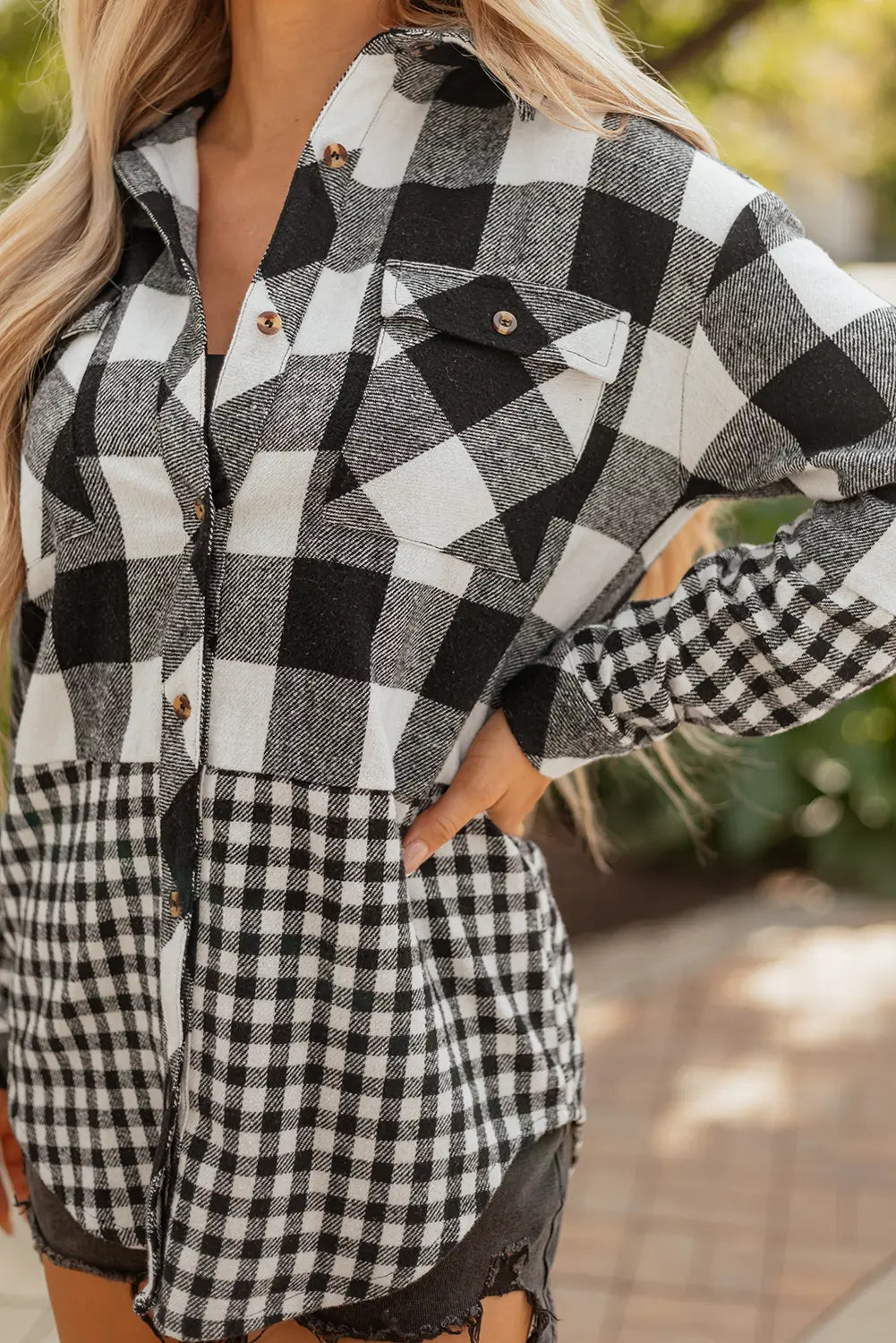 Person wearing a black and white checkered outfit with blurred background