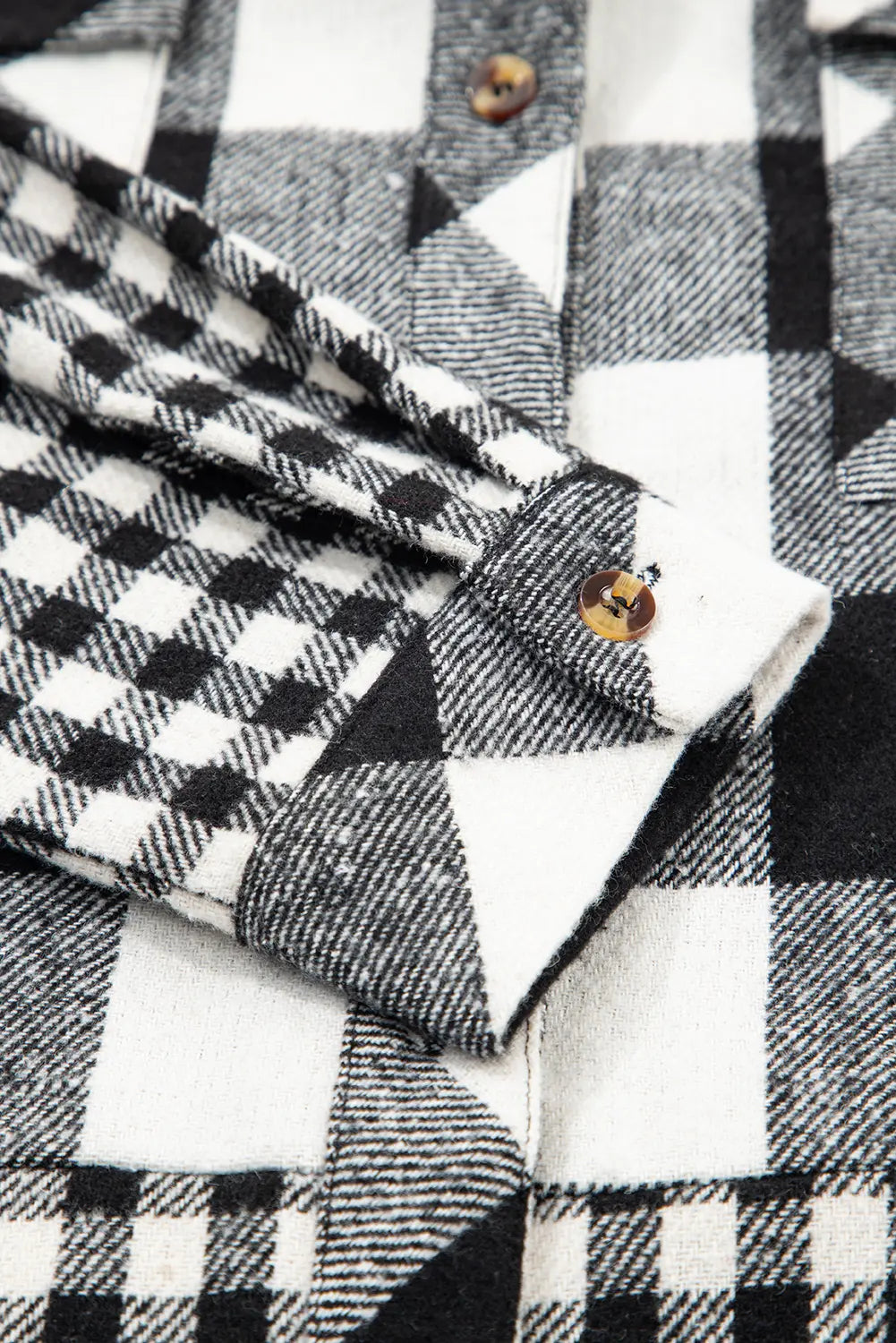 Close-up of a black and white checkered fabric with a button.