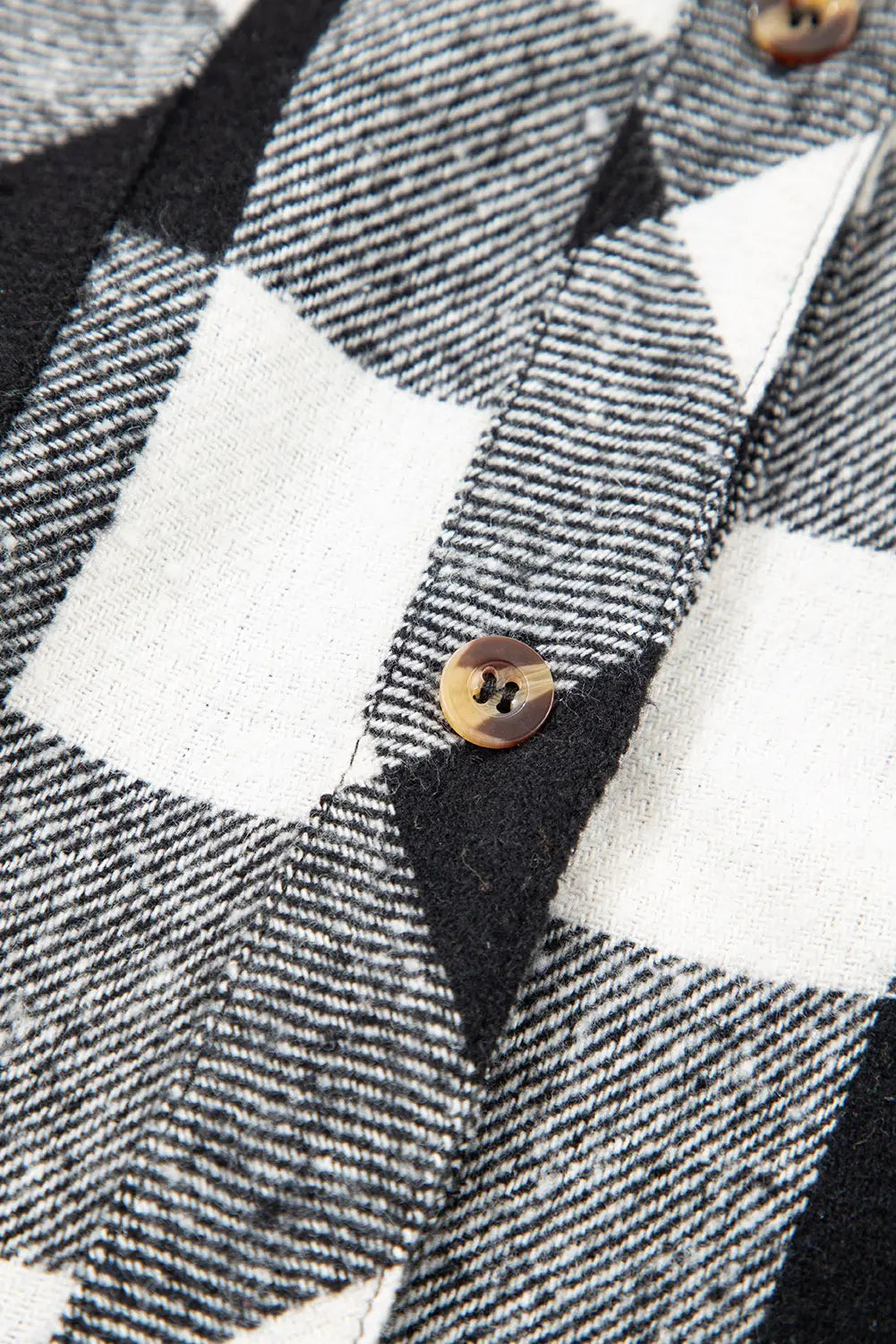 Close-up of a checkered fabric with buttons on a jacket