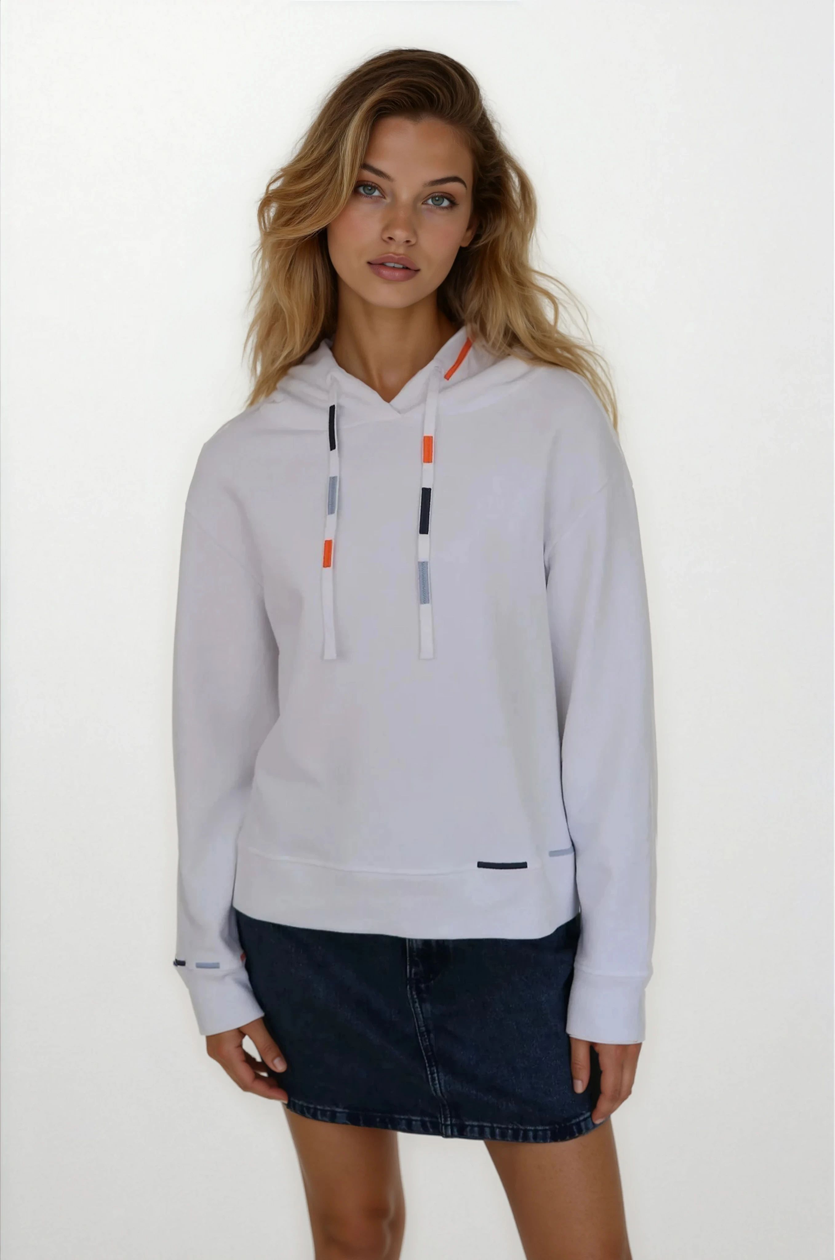 Woman wearing a light gray hoodie with colorful drawstrings on a white background
