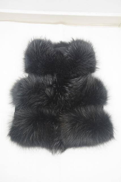Black fur vest on a white background