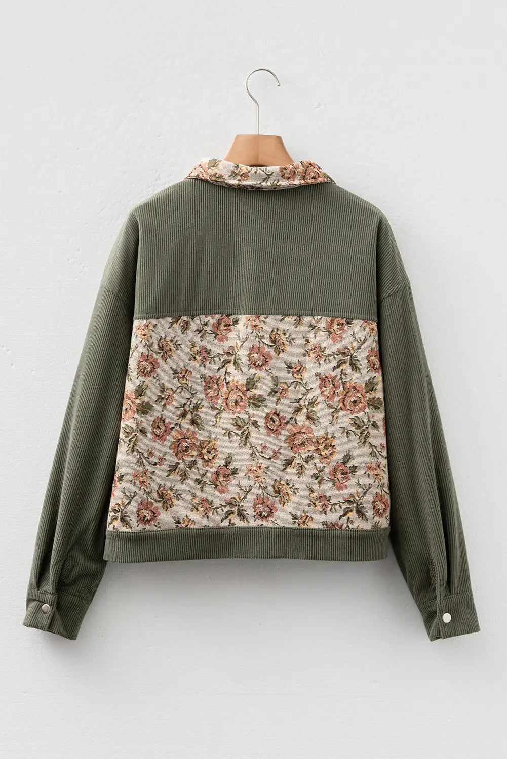 Green jacket with floral pattern on a white background