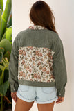 Person wearing a green jacket with floral back panel against a white background