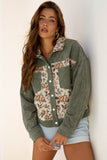 Woman wearing a green floral-patterned jacket against a white background