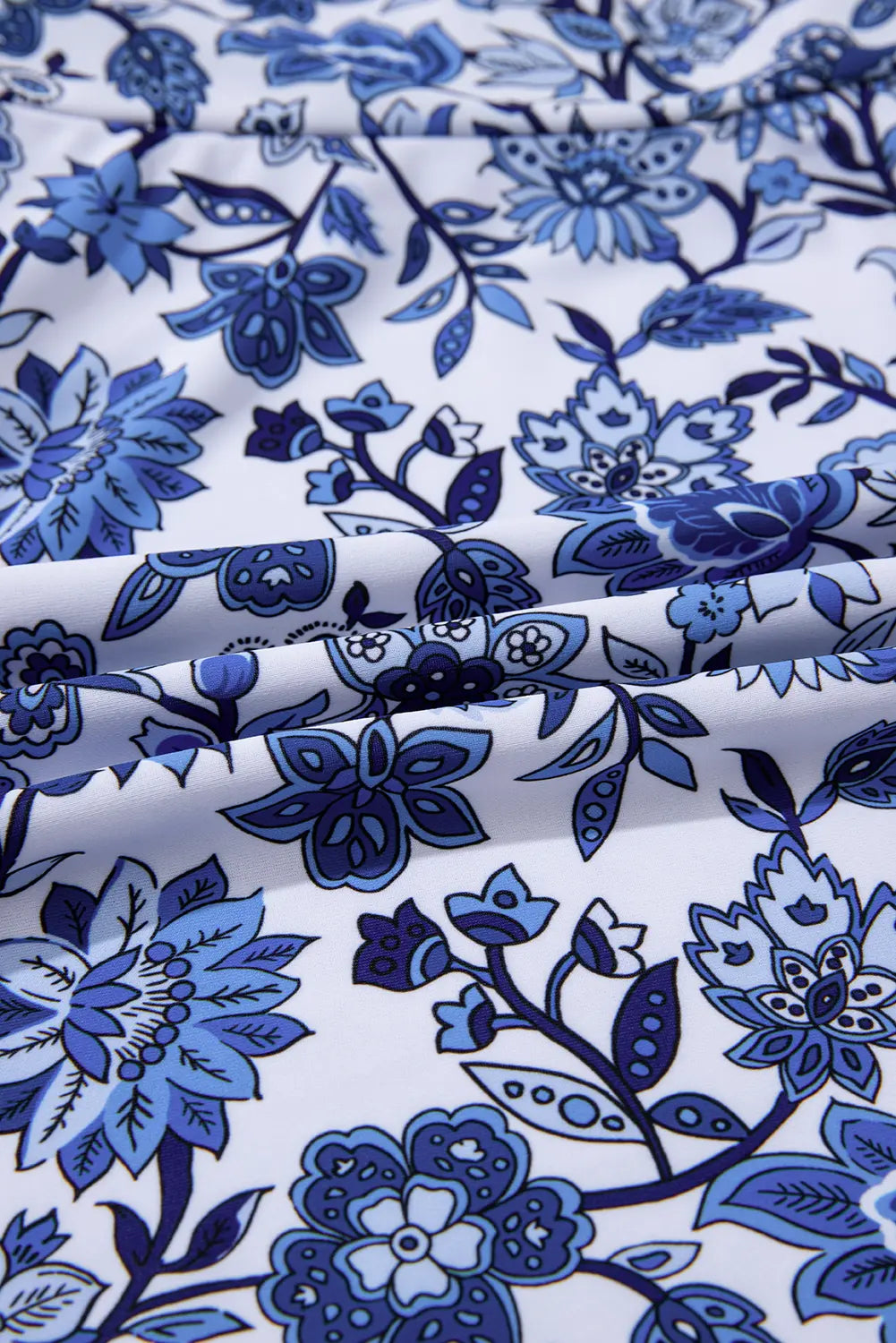 Blue floral pattern on white fabric