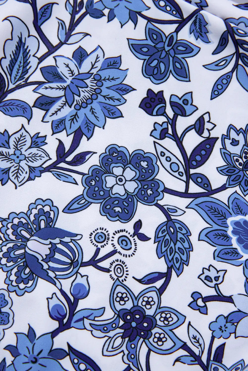 Close-up of blue floral pattern on white fabric