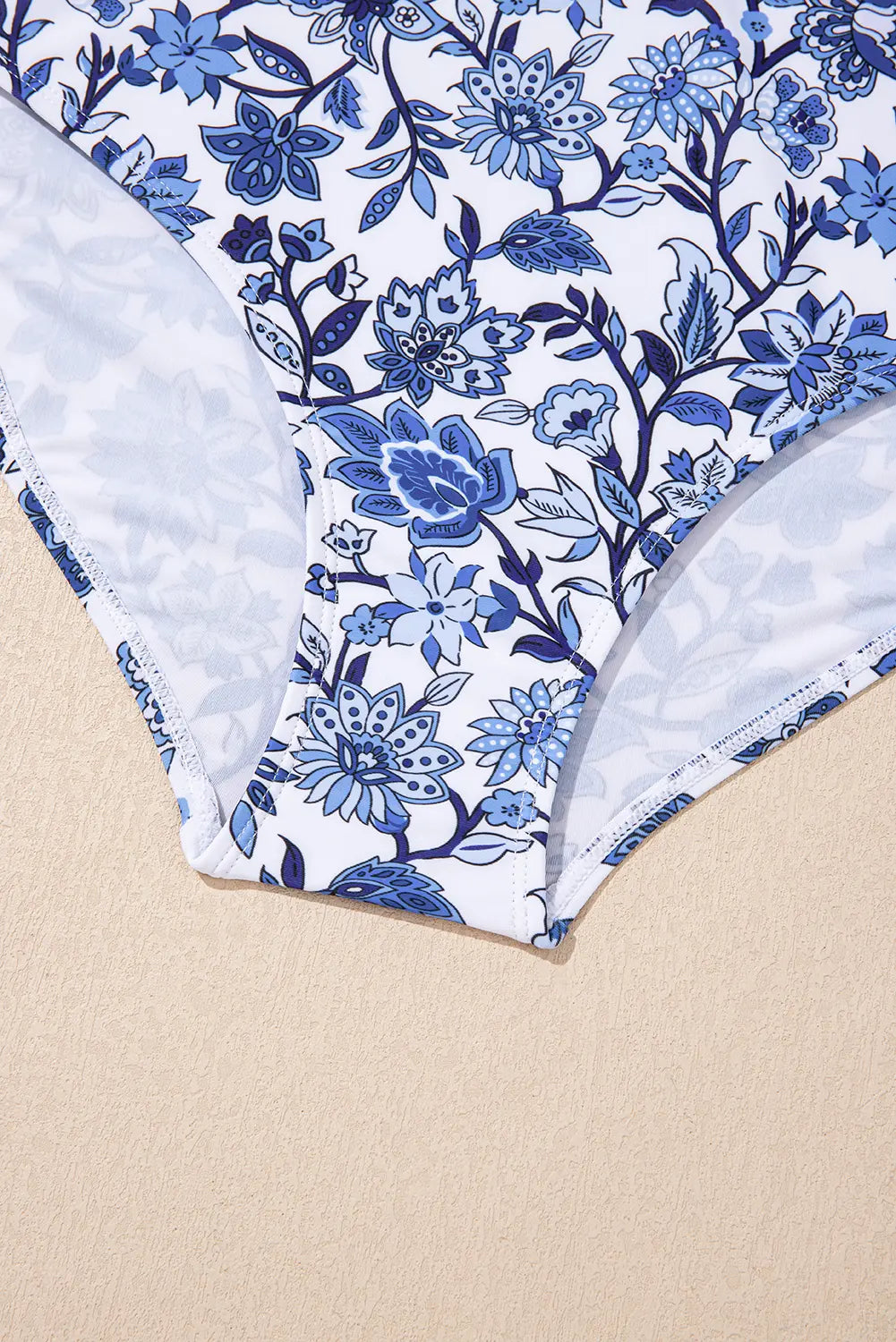 Blue floral patterned fabric on a beige background
