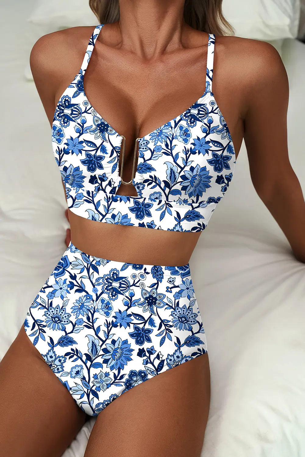 Blue and white floral two-piece swimsuit on a neutral background