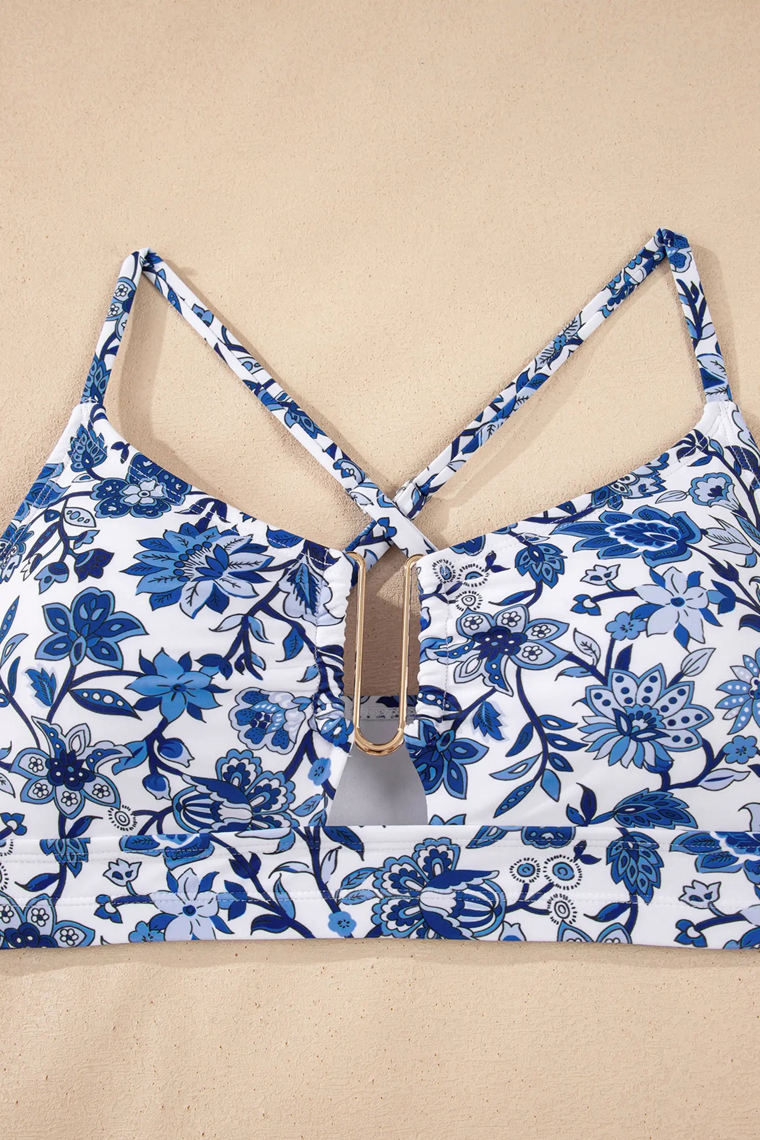 Blue floral-patterned top on a beige background