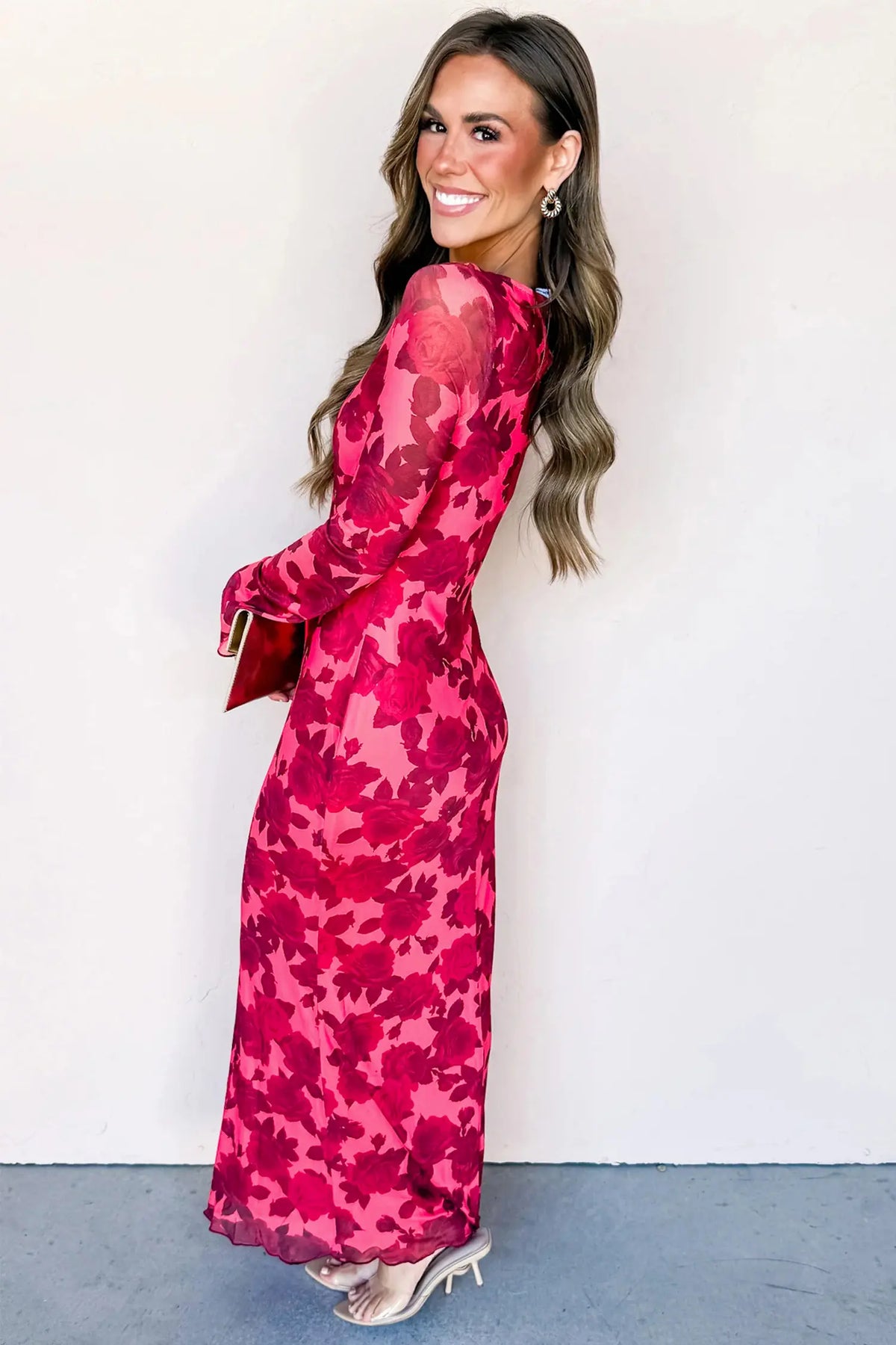 Woman wearing a pink camouflage dress against a white background