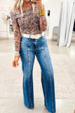 Person wearing a patterned top and blue jeans in an indoor setting