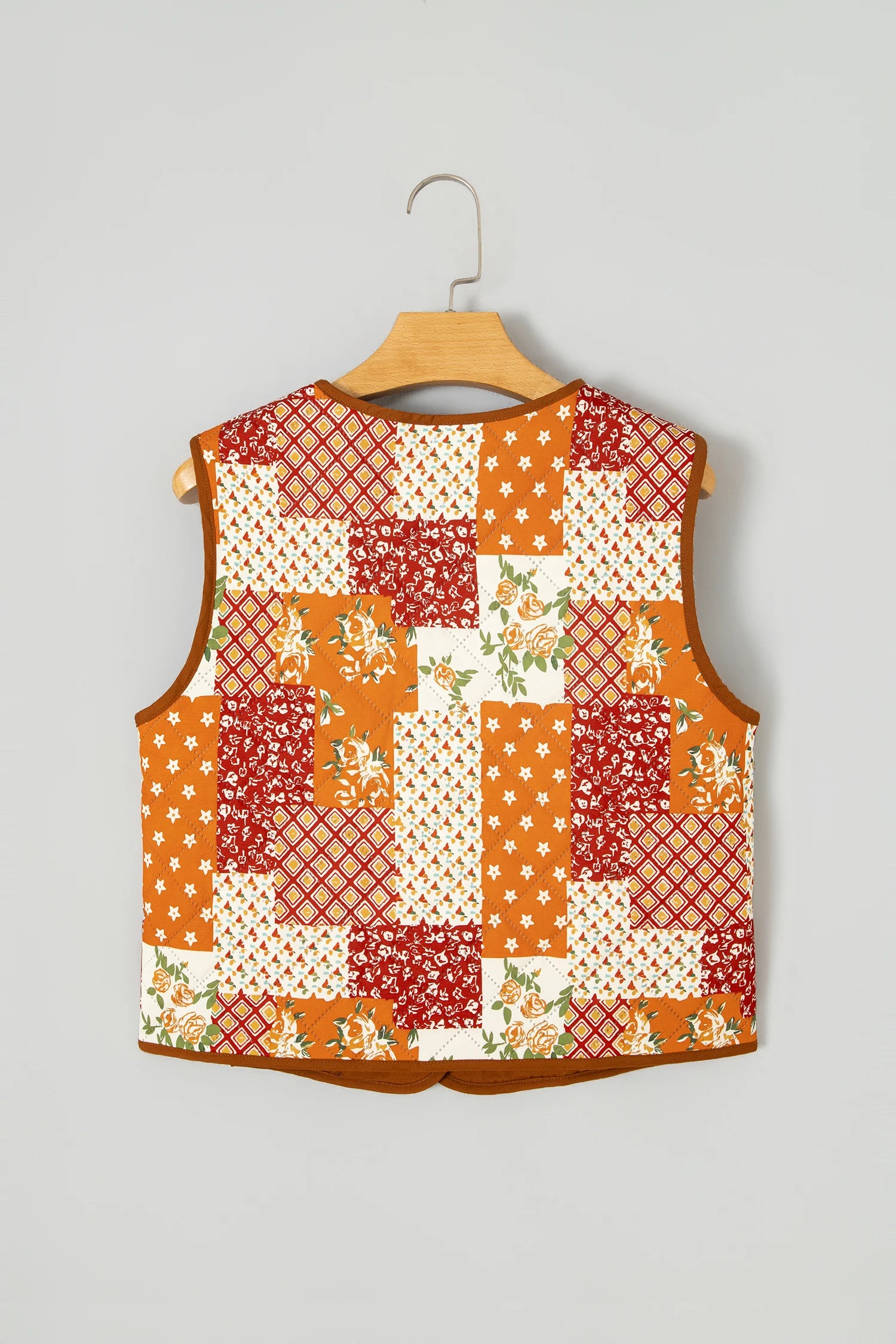 Sleeveless orange, red, and cream patchwork quilt vest