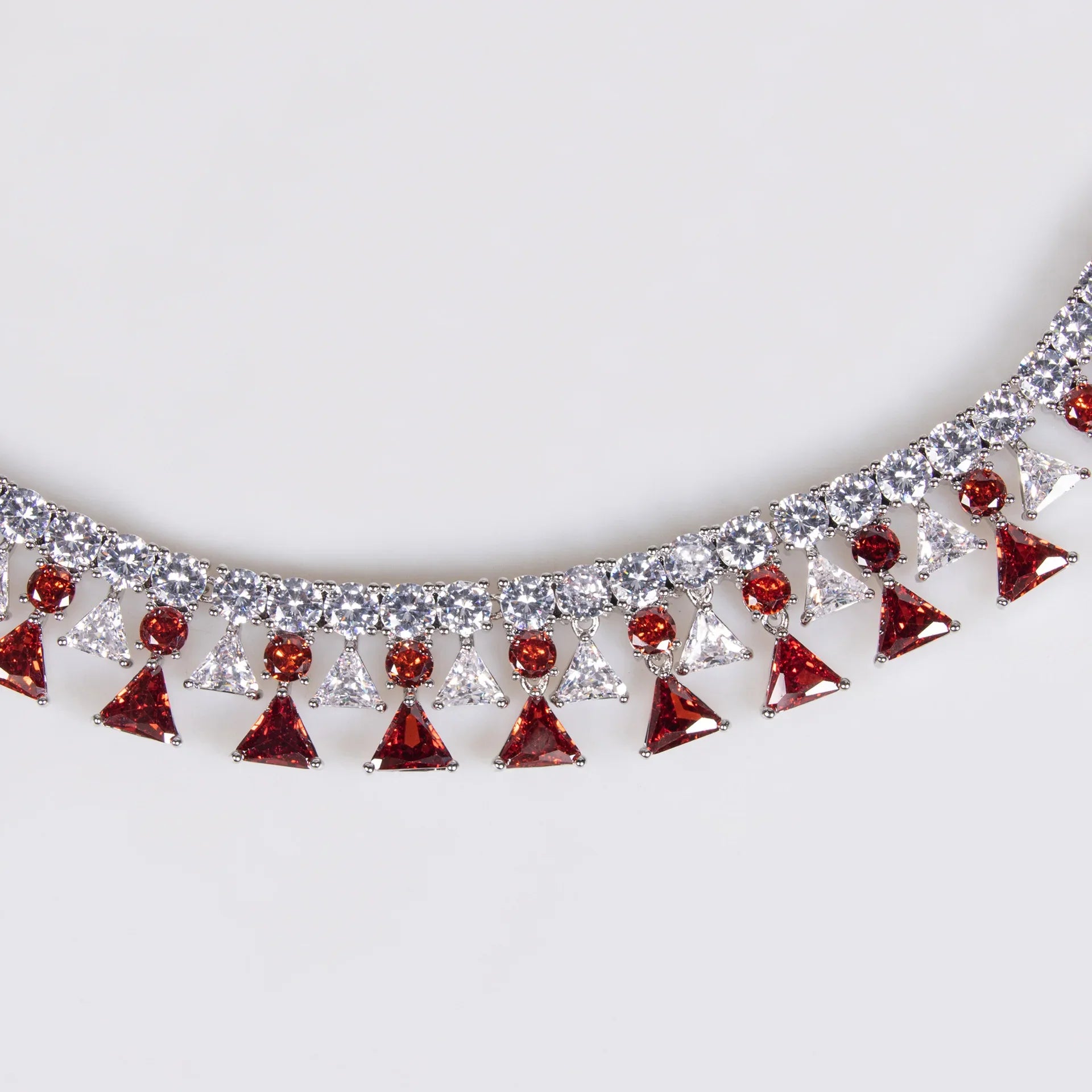 Necklace with red and clear gemstones on a white background