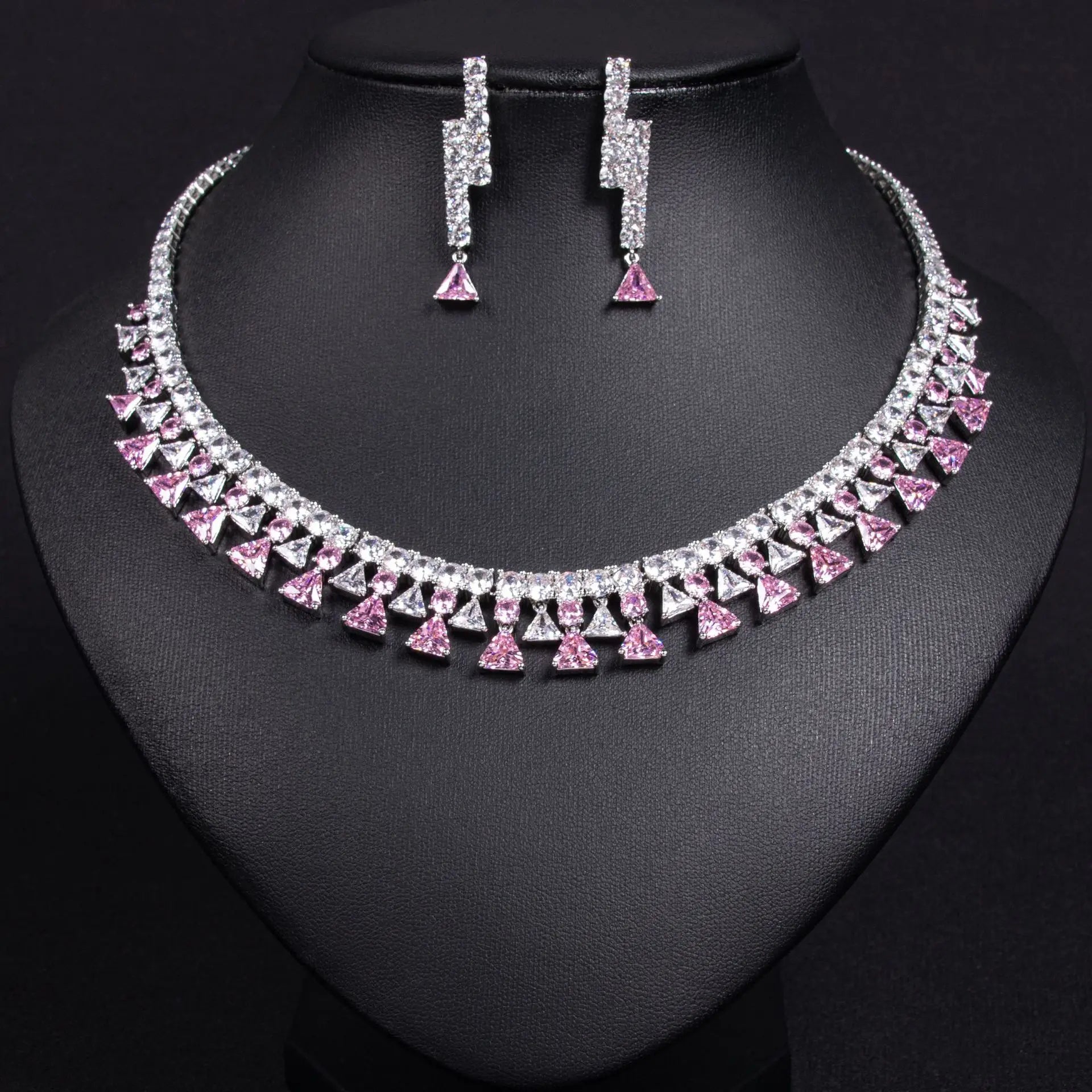 Silver necklace and earrings on a black mannequin