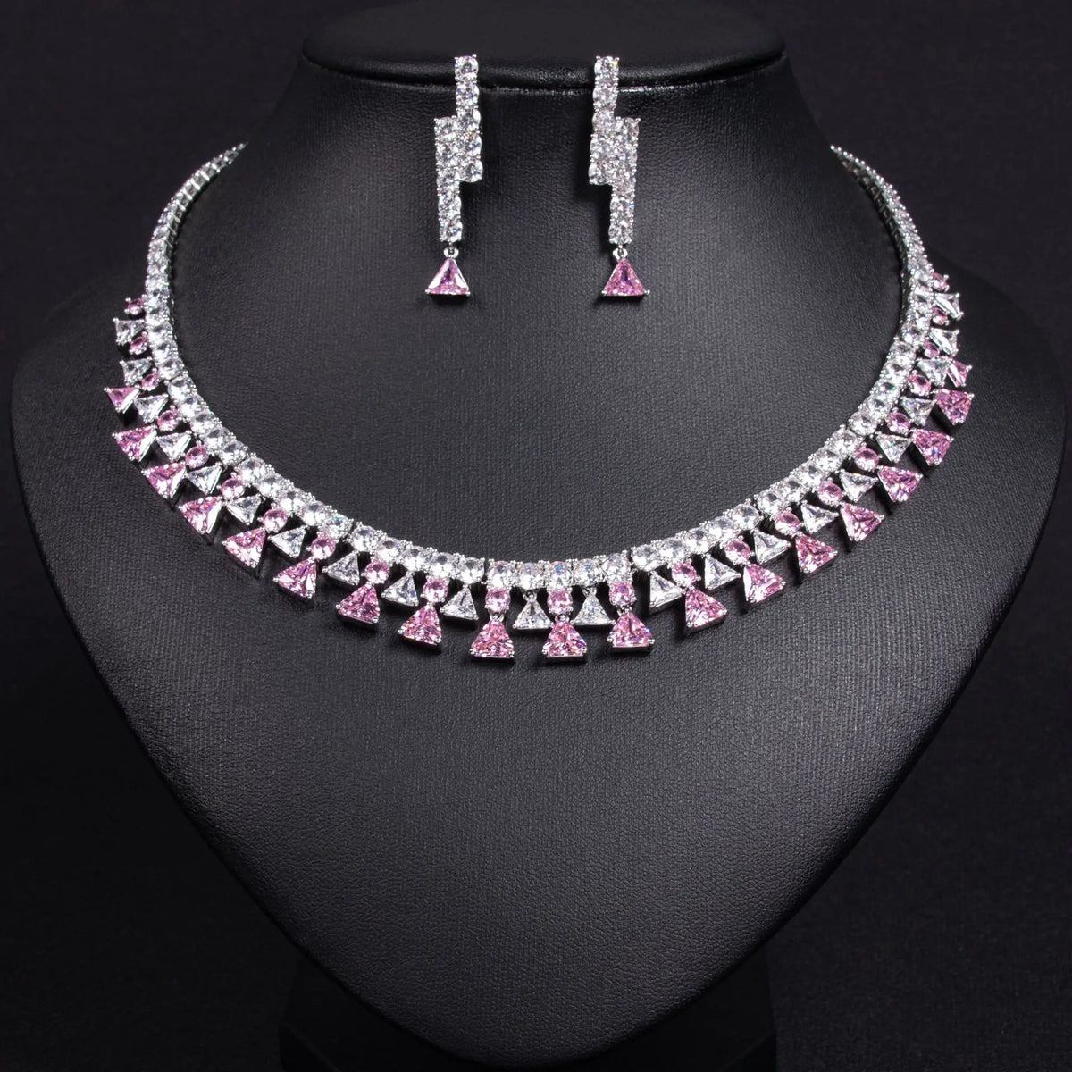 Silver necklace and earrings on a black mannequin