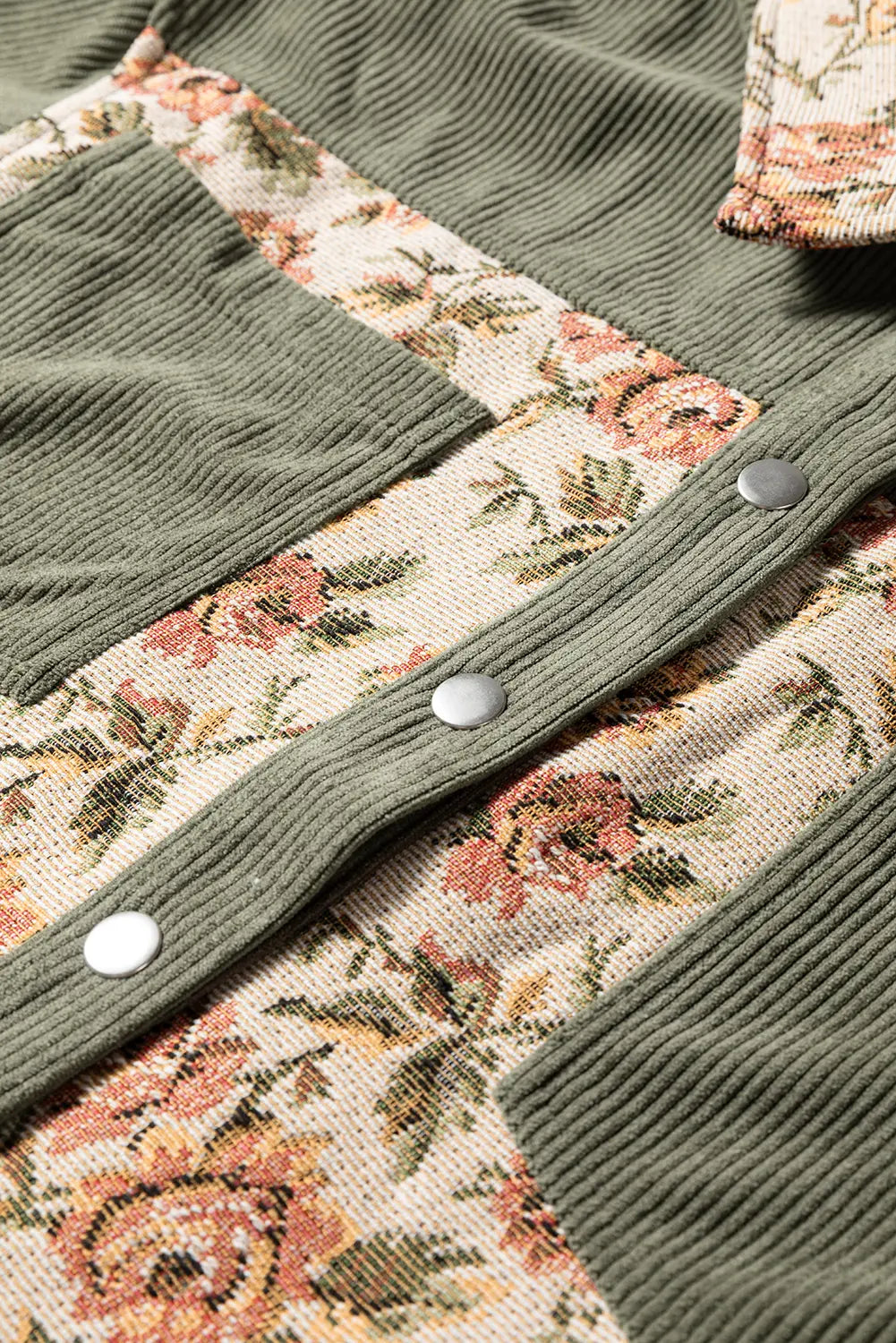 Close-up of a green knitted cardigan with floral patterned lining