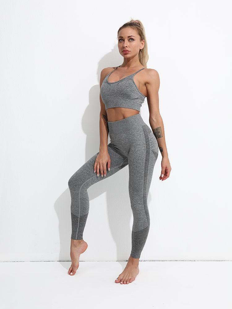 Woman wearing a gray athletic outfit on a white background