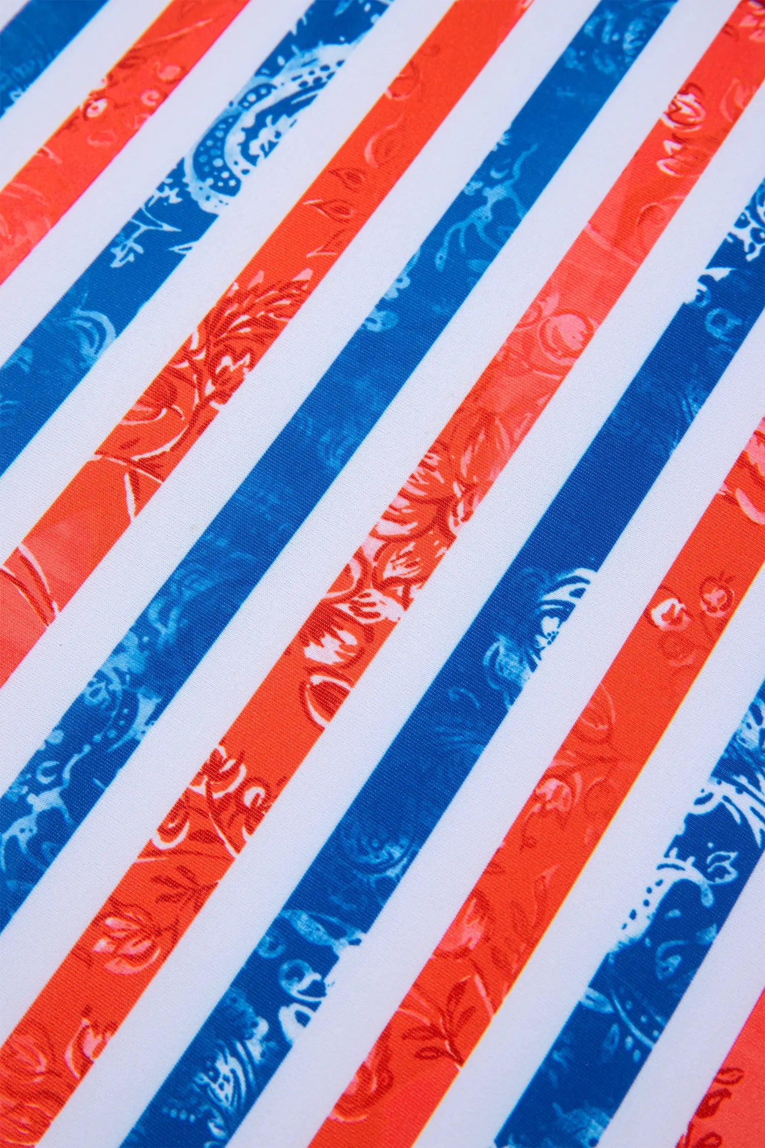 Close-up of red, white, and blue striped pattern with floral texture