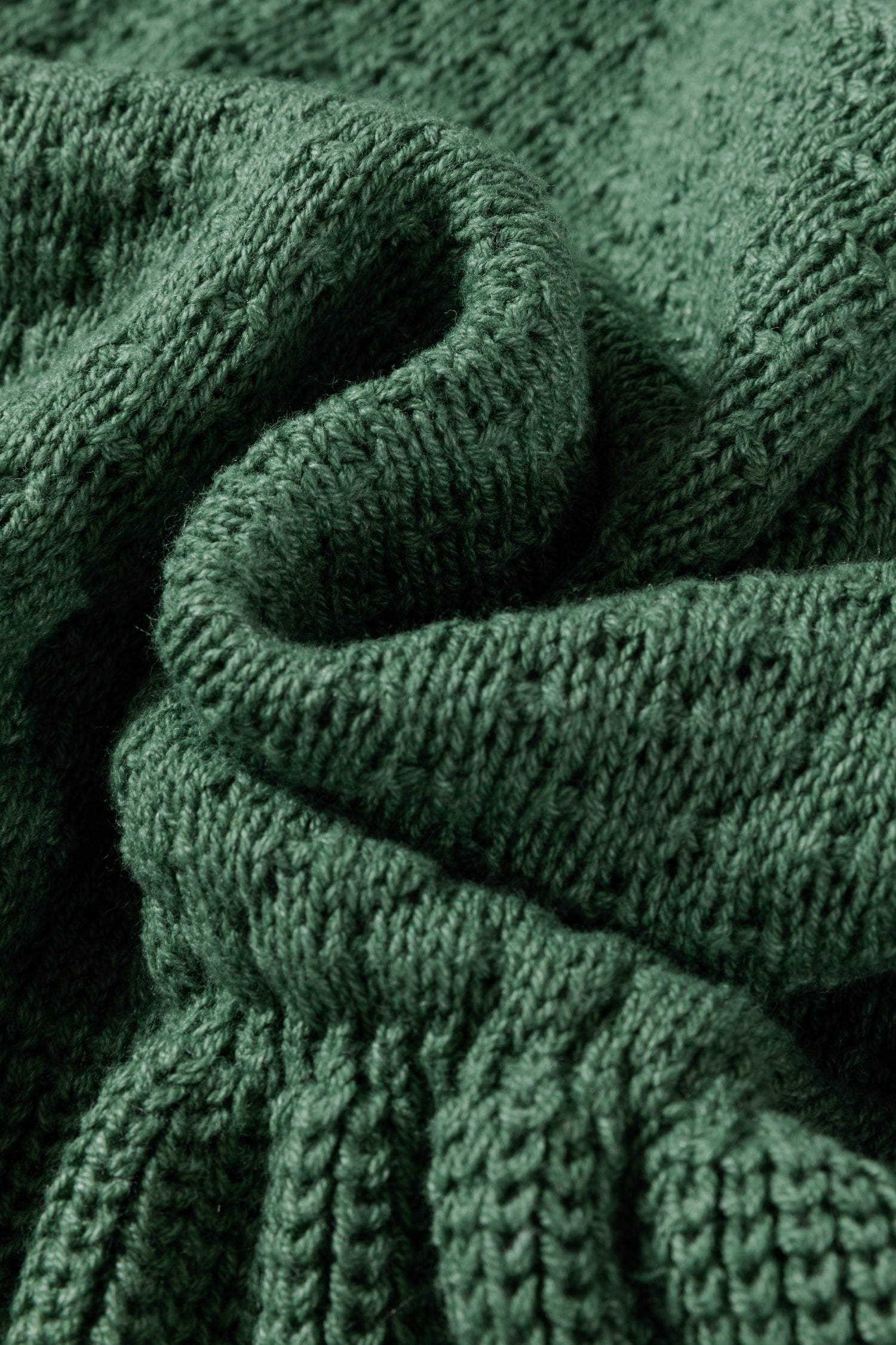 Close-up of a green knitted scarf with texture details