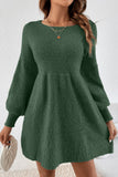 Green knitted dress worn by a person on a white background