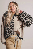 A woman wearing a fuzzy knit sweater with a mixed pattern of leopard print, solid beige, and brown stars, paired with khaki pants, against a plain light gray background.