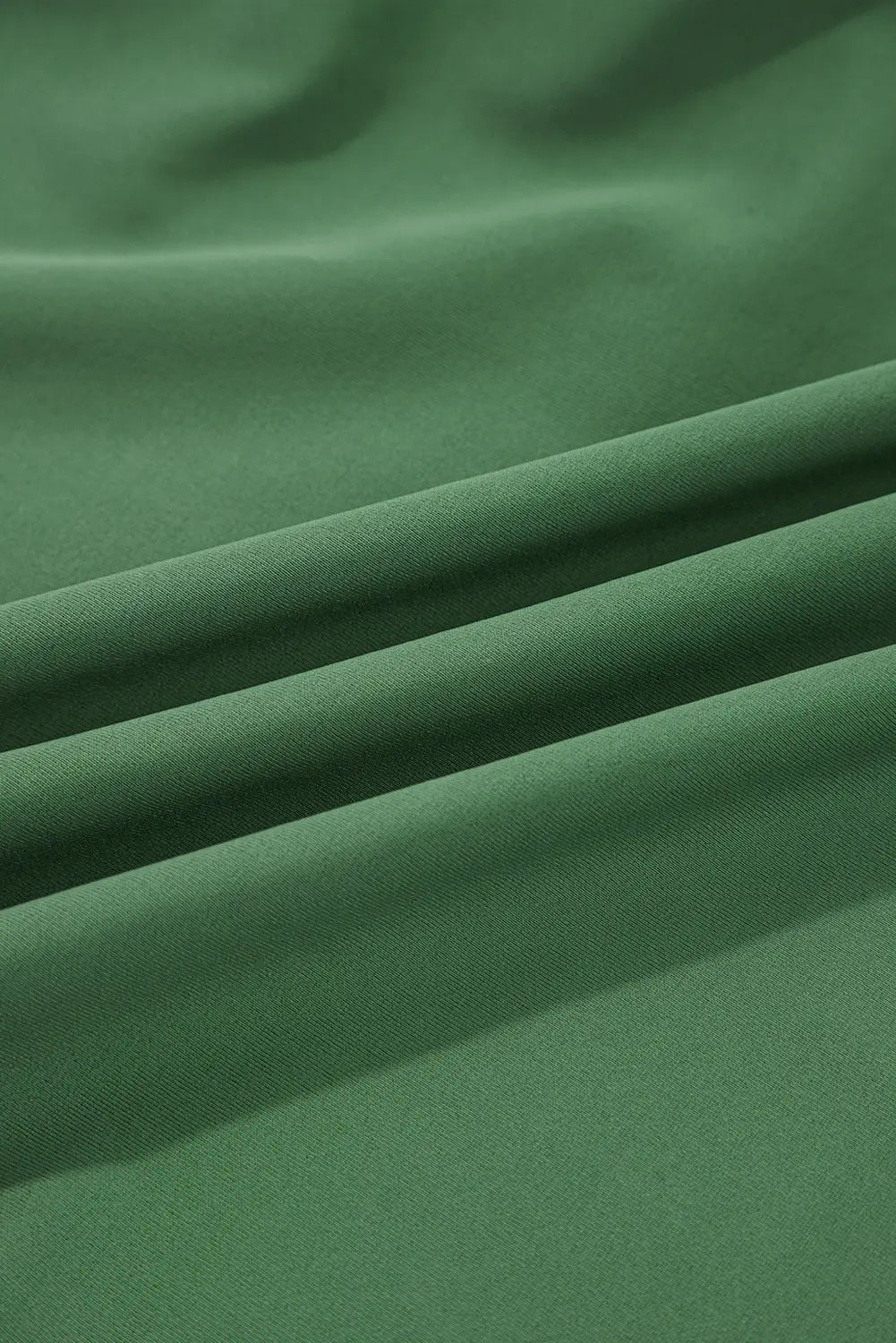 Close-up of green fabric with folds
