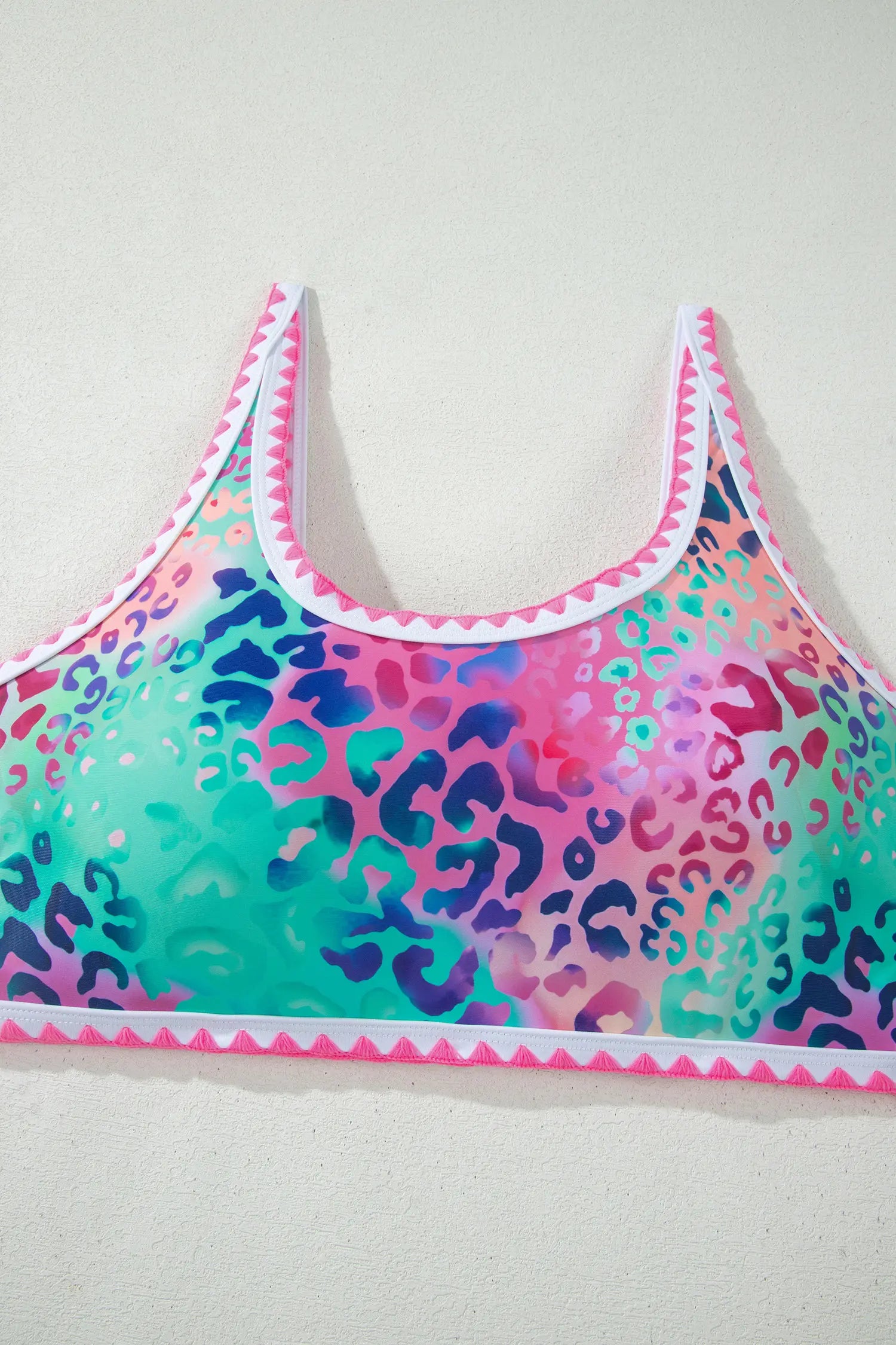 Colorful leopard print sports bra on a light gray background