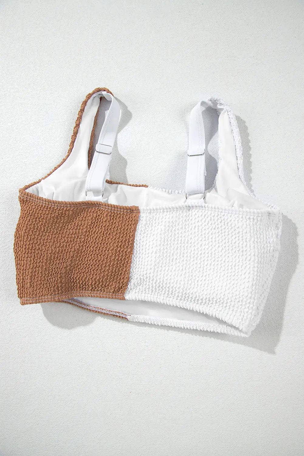 White and brown crochet top on a white background