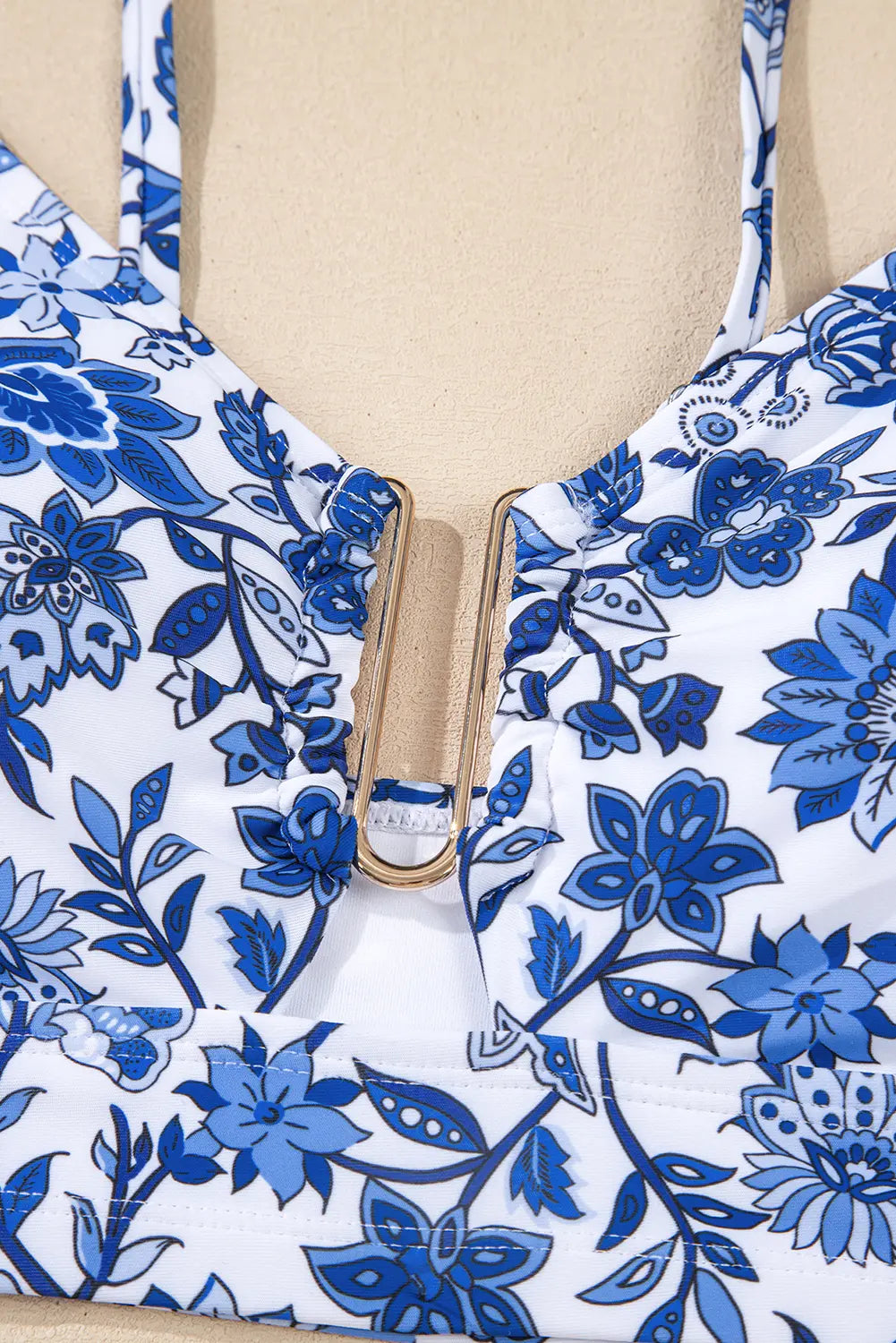 Blue floral patterned top on a mannequin with beige background