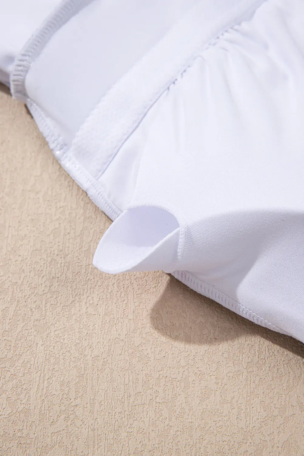 White fabric on a beige surface