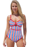 Woman wearing a red, white, and blue striped swimsuit on a white background